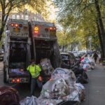 Sanitation workers collect trash, Saturday, Nov. 16, 2024, in the Brooklyn borough of New York.