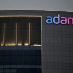 The logo of the Adani Group is seen on the facade of one of its buildings on the outskirts of Ahmedabad, India, April 13, 2021.