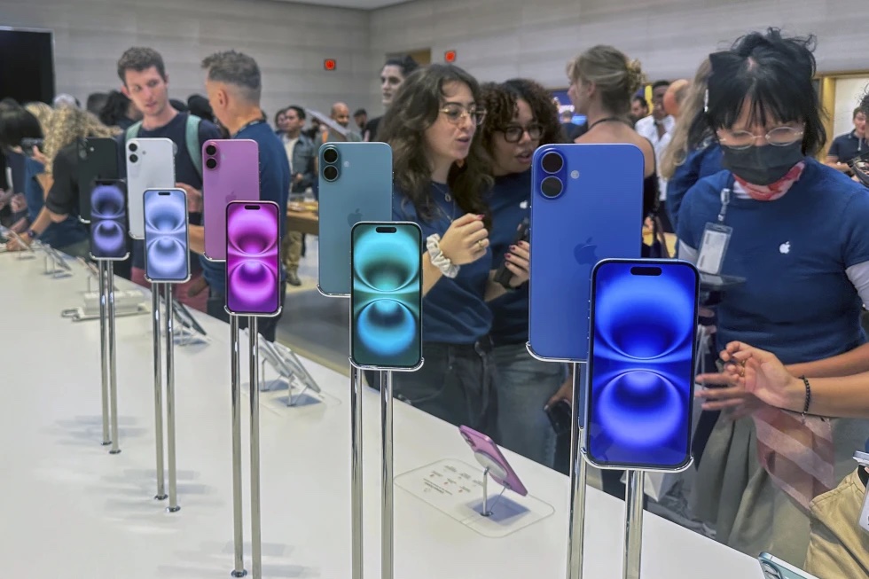 People gather near a display of iPhone 16’s at the Apple Store on 5th Ave. in New York on September 20, 2024.