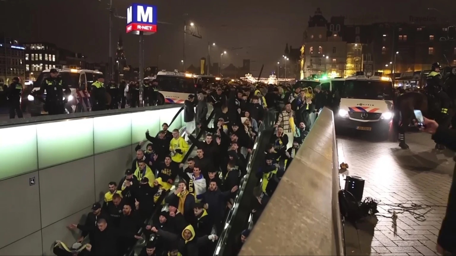 In this image taken from video, police escort Maccabi Tel Aviv supporters to the metro, after pro-Palestinian supporters marched near the soccer stadium, in Amsterdam, the Netherlands, Thursday, Nov. 7, 2024. 