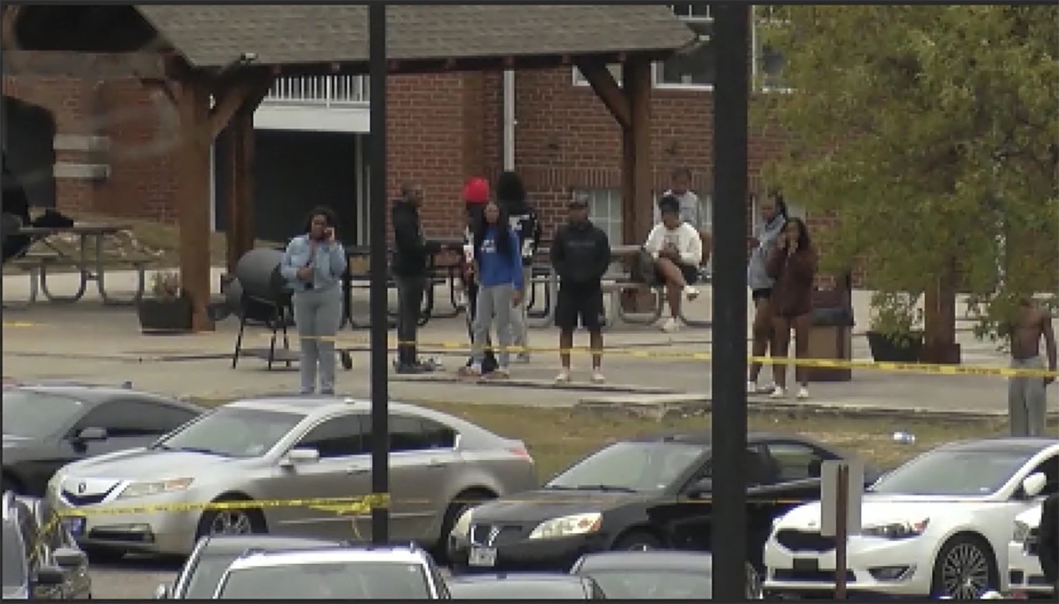 This image taken from video provided by WSFA shows people standing near the scene of an earlier shooting at Tuskegee University, Sunday, Nov. 10, 2024, in Tuskegee, Ala.