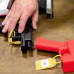 A federal firearms official displays several guns that are either entirely or partially 3D-printed.