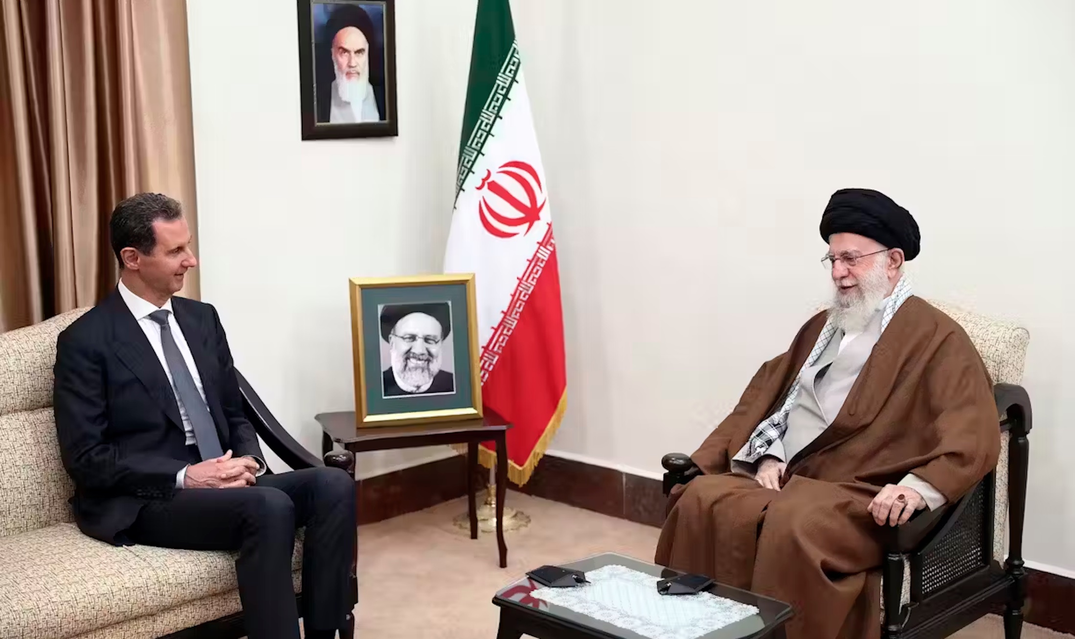 Iranian Supreme Leader Ayatollah Ali Khamenei, right, speaks with Syrian President Bashar al-Assad in Tehran in May 2024. 