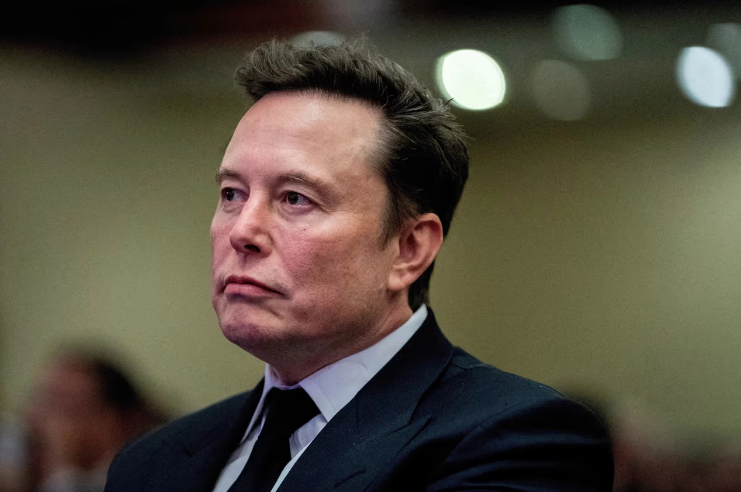 Tesla CEO and X owner Elon Musk listens as US President-elect Donald Trump speaks during a meeting with House Republicans at the Hyatt Regency hotel in Washington, DC, U.S. on November 13, 2024. 