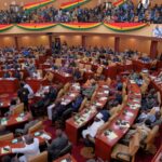 Parliamentarians and members of the public listen as Ghanaian President Nana Akufo-Addo delivers his annual state of the nation address to the parliament in Accra, Ghana, March 30, 2022.