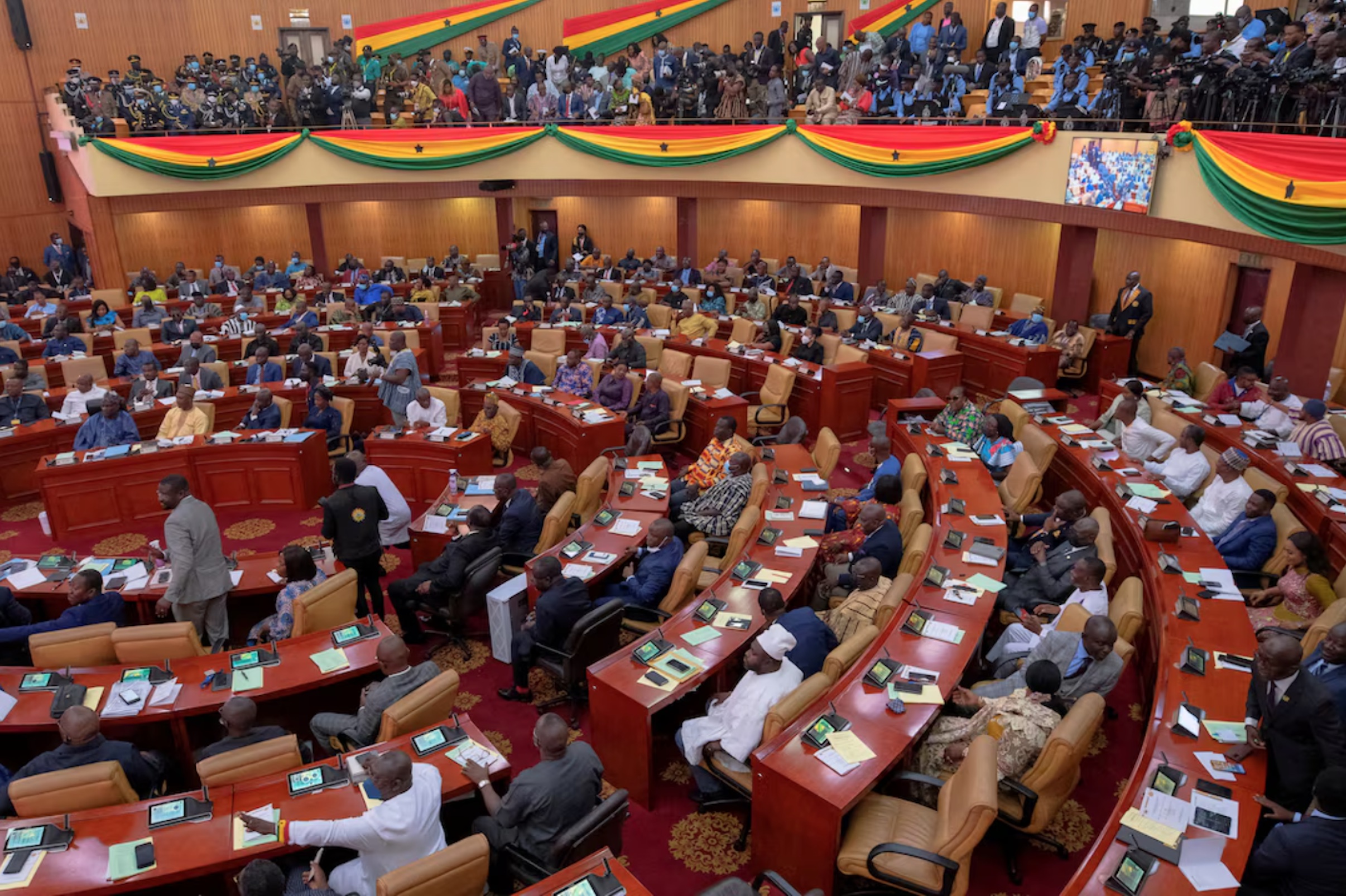 Parliamentarians and members of the public listen as Ghanaian President Nana Akufo-Addo delivers his annual state of the nation address to the parliament in Accra, Ghana, March 30, 2022.