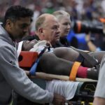 Miami Dolphins wide receiver Grant DuBose (88) is carted off the field after being injured during the second half of an NFL football game against the Houston Texans, Sunday, Dec. 15, 2024, in Houston.