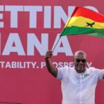 National Democratic Congress (NDC) presidential candidate and former Ghanaian President John Dramani Mahama holds a national flag as he waves to supporters during his final election campaign rally in Accra, Ghana December 5, 2024.