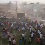 People scramble in Nzerekore, Guinea, where local officials said a deadly stampede ensued at a stadium following fan clashes during a soccer match, December 1, 2024, in this still image obtained from a social media video.