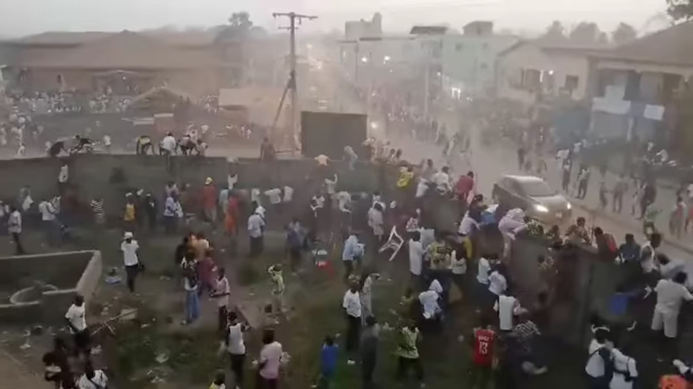 People scramble in Nzerekore, Guinea, where local officials said a deadly stampede ensued at a stadium following fan clashes during a soccer match, December 1, 2024, in this still image obtained from a social media video. 