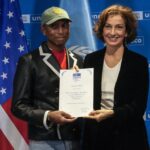 Pharrell Williams, left, holds his diploma of Goodwill Ambassador for for Arts, Education and Entrepreneurship as he poses with UNESCO Director General Audrey Azoulay at UNESCO headquarters in Paris, Tuesday, Dec. 17, 2024.