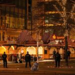 Security guards stand in front of a cordoned-off Christmas Market after a car crashed into a crowd of people, in Magdeburg, Germany, Saturday early morning, Dec. 21, 2024.