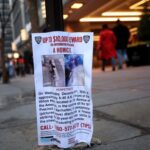 People walk next to a poster outside the Hilton hotel near the scene where the CEO of UnitedHealthcare Brian Thompson was shot dead in Midtown Manhattan, in New York City, U.S., December 5, 2024.