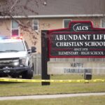 Emergency vehicles are parked outside the Abundant Life Christian School in Madison, Wis., following a shooting, Monday, Dec. 16, 2024.