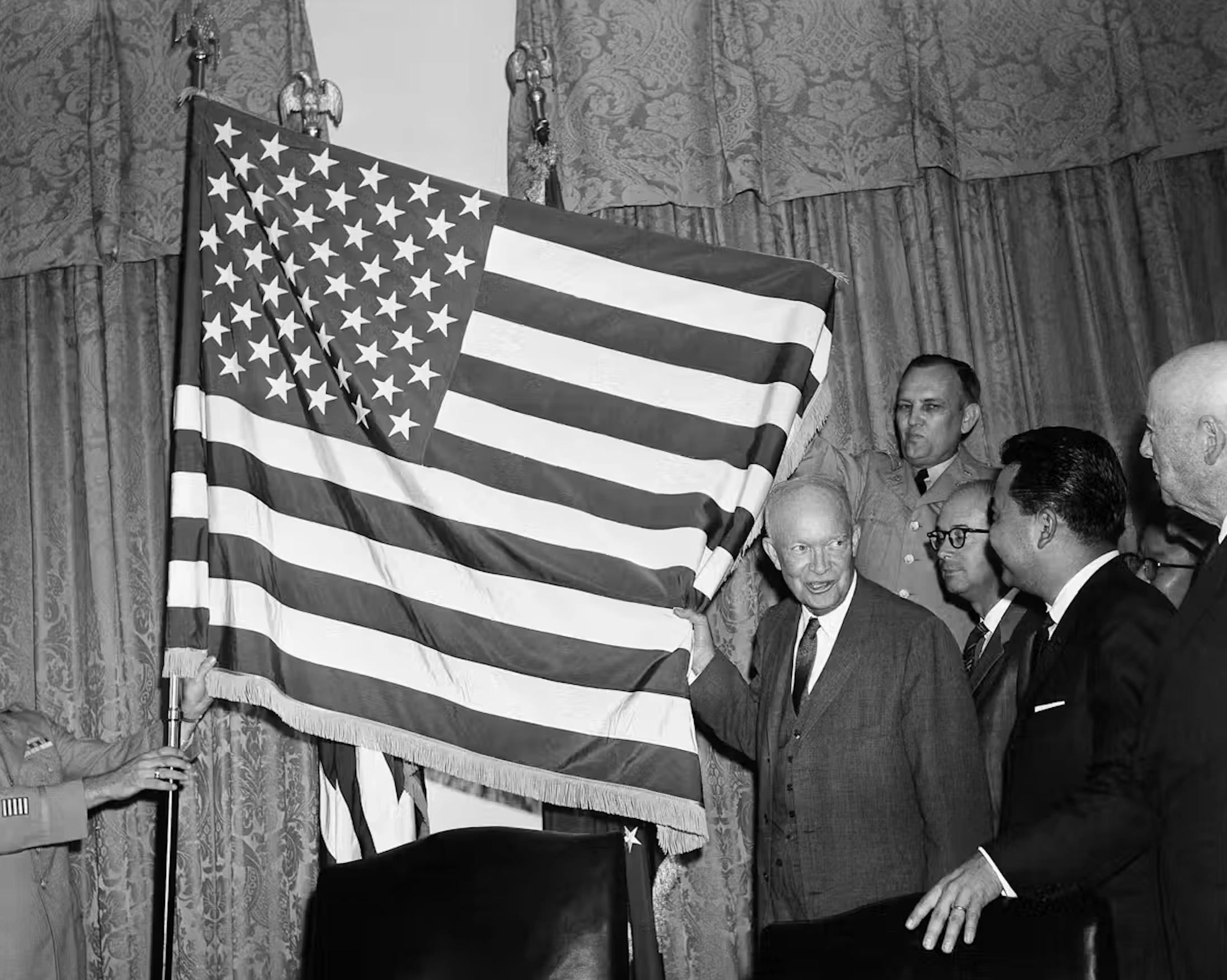 U.S. President Dwight Eisenhower helps unfurl the new 50-star flag in Washington in August 1959 after signing a proclamation making Hawaii the 50th state of the union. 