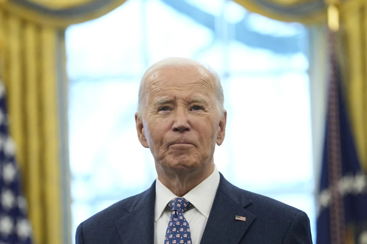 President Joe Biden pauses during a photo opportunity with Medal of Valor recipients in the Oval Office of the White House in Washington, Friday, Jan. 3, 2025.