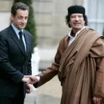 French President Nicolas Sarkozy, left, greets Libyan leader Col. Moammar Gadhafi upon his arrival at the Elysee Palace