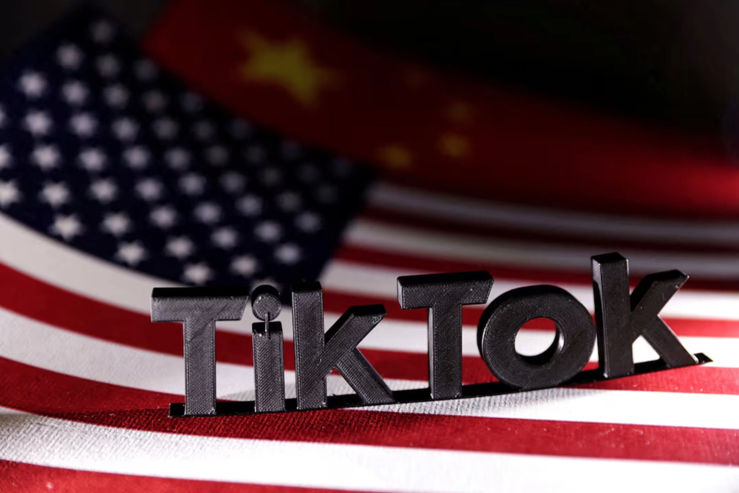 TikTok logo is placed on the U.S. and Chinese flags in this illustration taken, April 25, 2024.