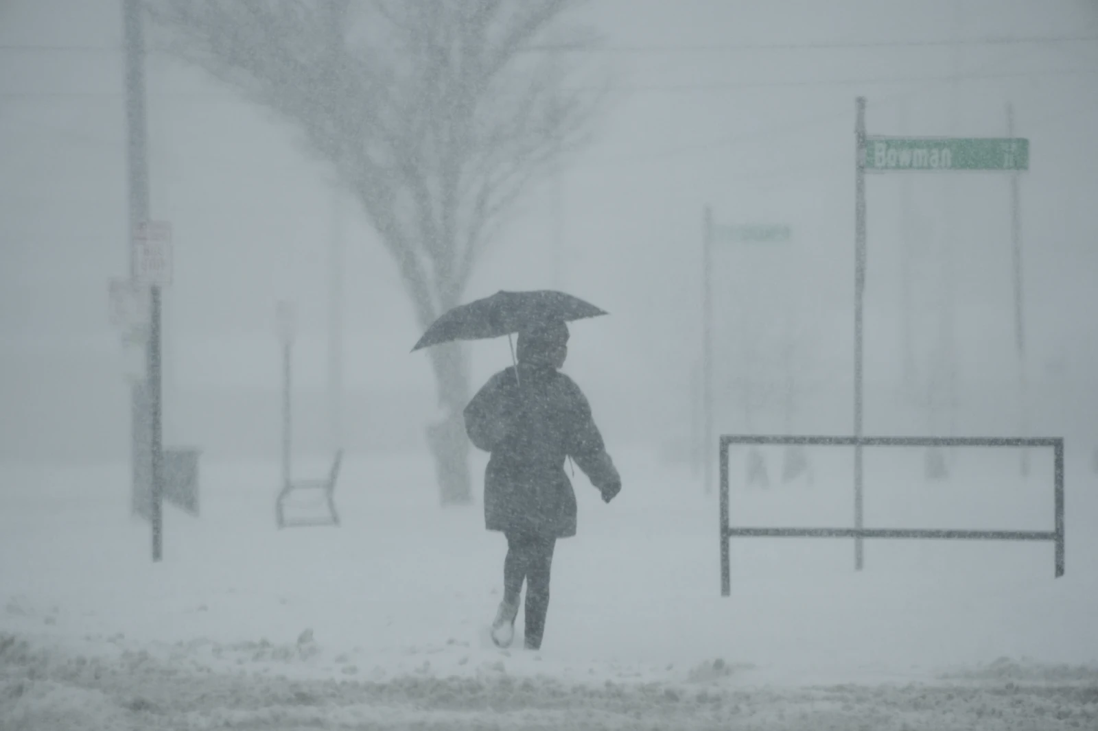 A person holds an umbrella as they walk during a winter storm, Monday, Jan. 6, 2025, in Cincinnati. 